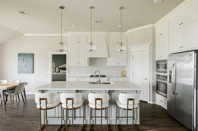 10800 NW 5th St, Yukon, OK 73099 - kitchen with appliances with stainless steel finishes, dark wood-type flooring, backsplash, light countertops, and white cabinets