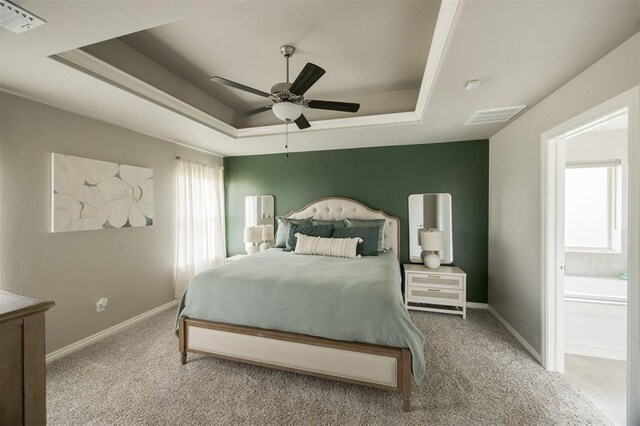 10800 NW 5th St, Yukon, OK 73099 - carpeted bedroom featuring a raised ceiling and a ceiling fan