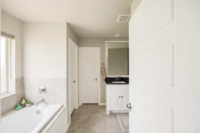 10800 NW 5th St, Yukon, OK 73099 - full bathroom featuring healthy amount of natural light, a bath, vanity, and tile patterned flooring