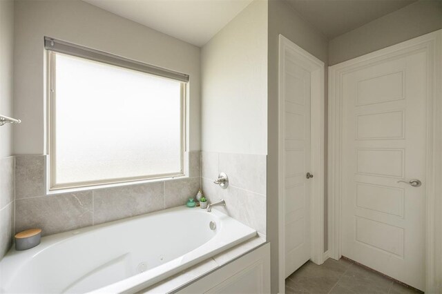 10800 NW 5th St, Yukon, OK 73099 - full bathroom featuring a tub with jets and tile patterned floors