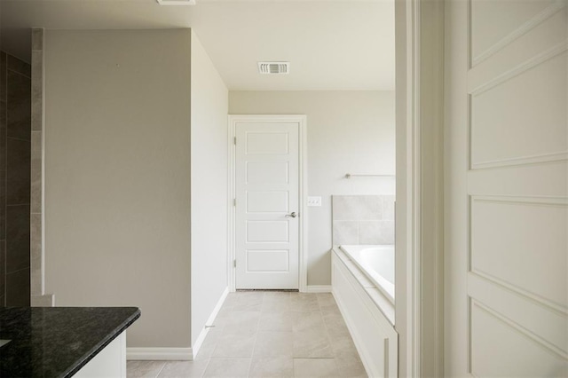 10800 NW 5th St, Yukon, OK 73099 - full bathroom with a garden tub, vanity, and tile patterned floors