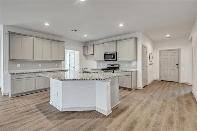 14500 Gravity Falls Ln, Oklahoma City, OK 73142 - kitchen with stainless steel appliances, gray cabinetry, light wood-style flooring, and recessed lighting