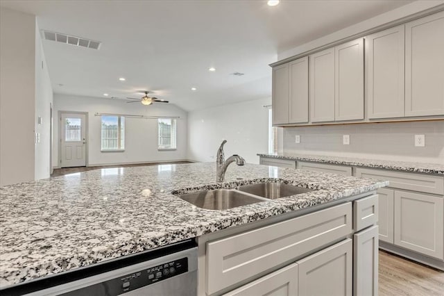 14500 Gravity Falls Ln, Oklahoma City, OK 73142 - kitchen featuring a ceiling fan, stainless steel dishwasher, recessed lighting, backsplash, and light stone countertops