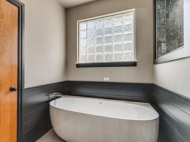 3805 Highridge, Edmond, OK 73003 - full bath featuring a soaking tub and a wainscoted wall