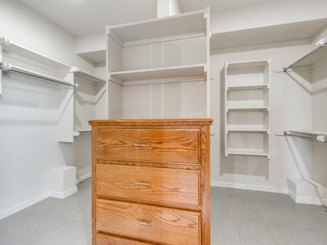 3805 Highridge, Edmond, OK 73003 - spacious closet featuring tile patterned flooring