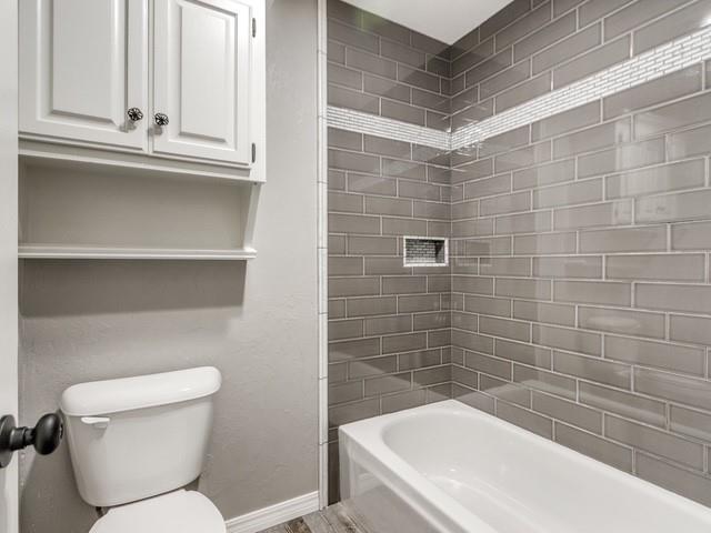 3805 Highridge, Edmond, OK 73003 - full bath featuring baseboards and shower / bath combination