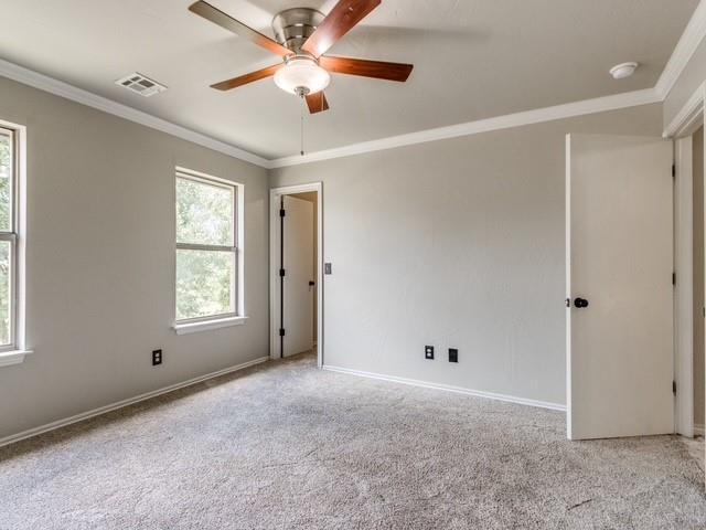 3805 Highridge, Edmond, OK 73003 - unfurnished bedroom featuring crown molding, carpet flooring, and a ceiling fan