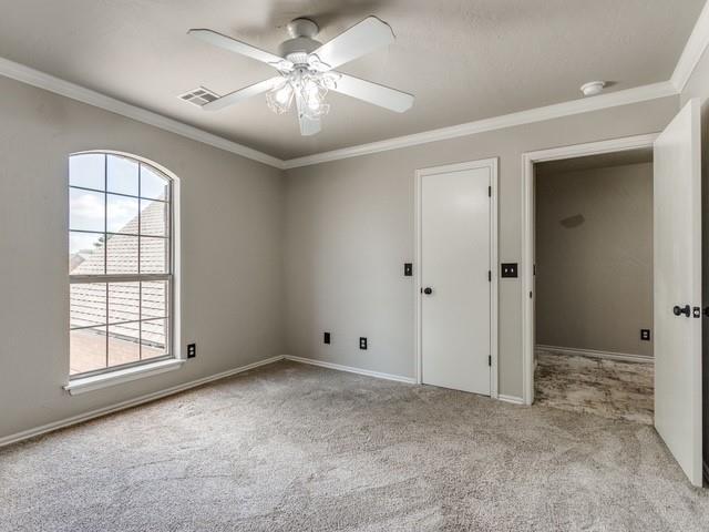 3805 Highridge, Edmond, OK 73003 - carpeted empty room with ceiling fan, ornamental molding, and a smoke detector