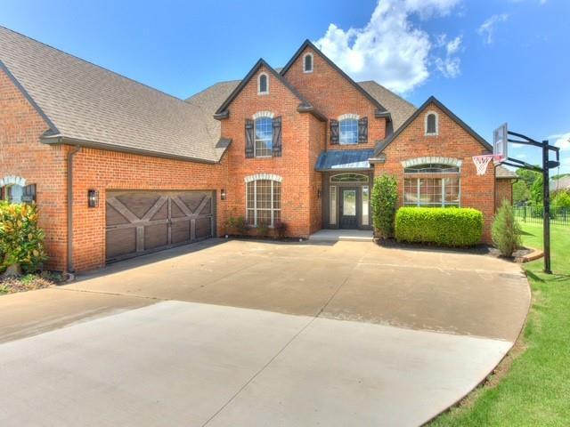 3805 Highridge, Edmond, OK 73003 - view of front of house with brick siding, driveway, roof with shingles, and a garage