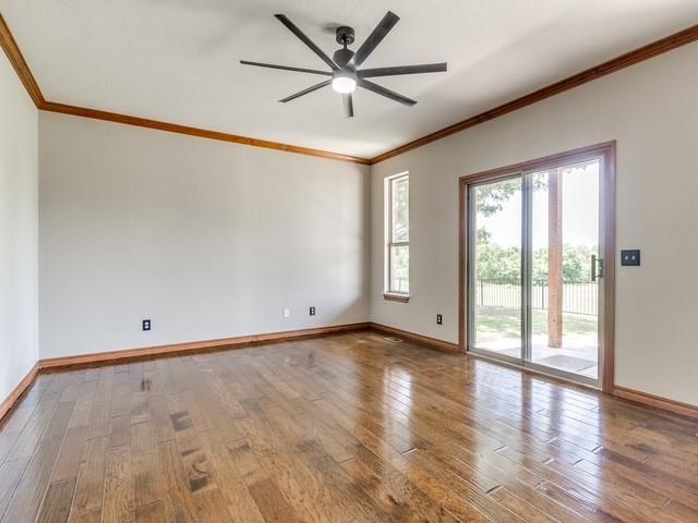 3805 Highridge, Edmond, OK 73003 - unfurnished room featuring crown molding, a ceiling fan, and hardwood / wood-style floors