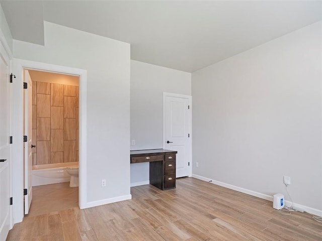 19608 Dalemead Way, Edmond, OK 73012 - unfurnished bedroom featuring light wood-style flooring and ensuite bath