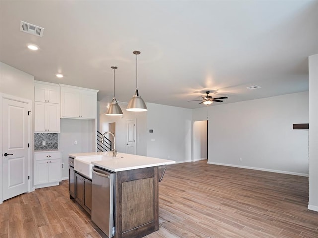 19608 Dalemead Way, Edmond, OK 73012 - kitchen with dishwasher, a ceiling fan, white cabinets, light wood-style floors, and recessed lighting