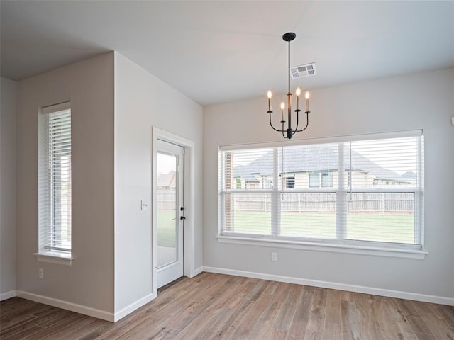19608 Dalemead Way, Edmond, OK 73012 - unfurnished dining area with a chandelier and wood finished floors