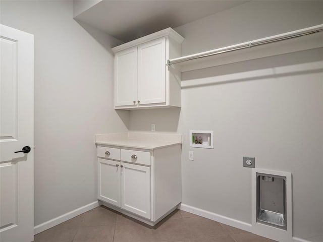 19608 Dalemead Way, Edmond, OK 73012 - laundry room with hookup for an electric dryer, hookup for a washing machine, light tile patterned floors, and cabinet space