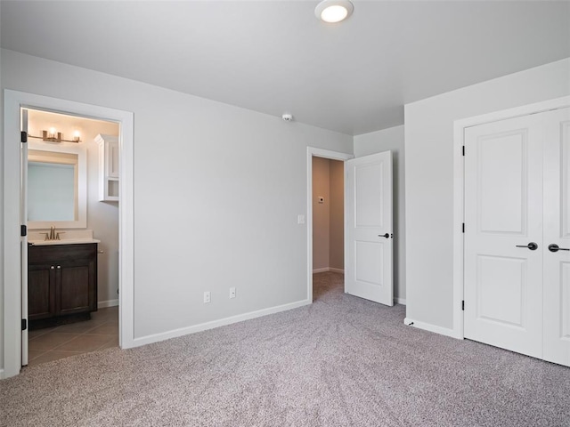 19608 Dalemead Way, Edmond, OK 73012 - unfurnished bedroom with light colored carpet, ensuite bathroom, and a closet