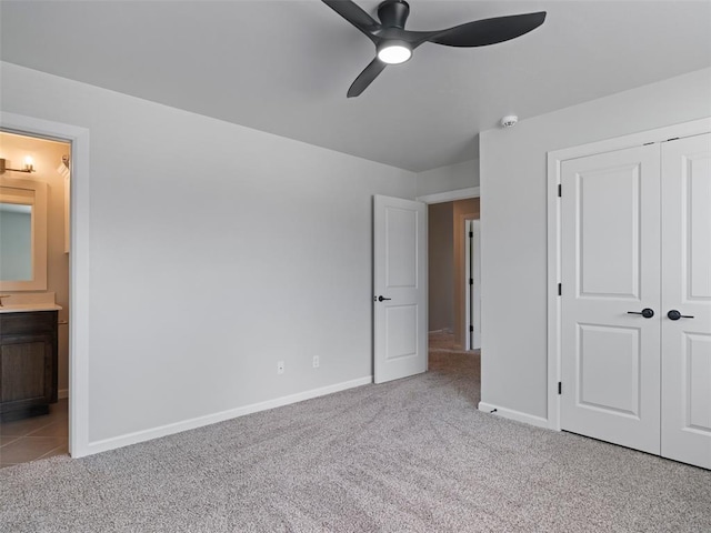 19608 Dalemead Way, Edmond, OK 73012 - unfurnished bedroom featuring carpet flooring, a closet, connected bathroom, and a ceiling fan