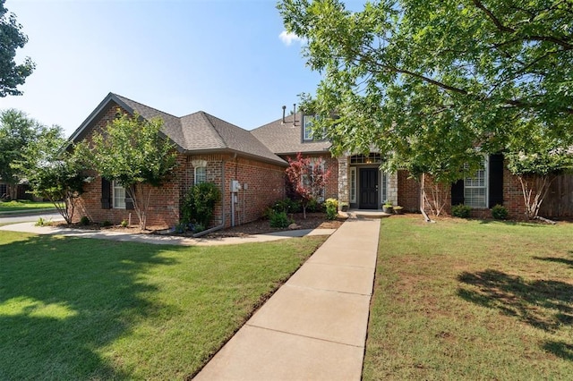 2917 Stafford Rd, Edmond, OK 73012 - view of front of property with a front yard, brick siding, and roof with shingles