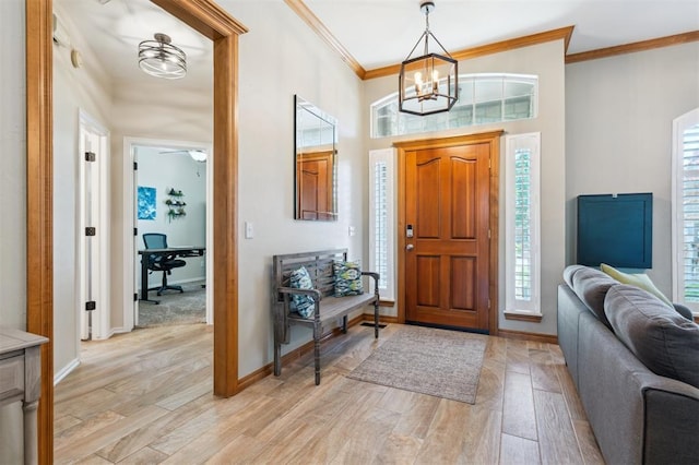 2917 Stafford Rd, Edmond, OK 73012 - foyer entrance featuring ornamental molding, a chandelier, and light wood finished floors
