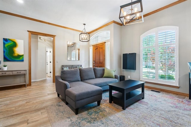 2917 Stafford Rd, Edmond, OK 73012 - living area featuring a chandelier, ornamental molding, and wood finished floors