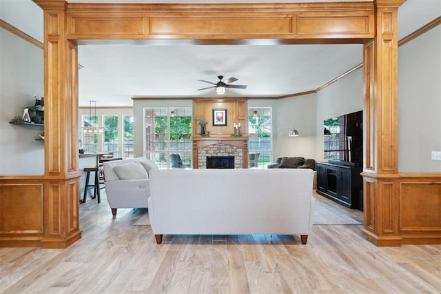 2917 Stafford Rd, Edmond, OK 73012 - living area featuring ornamental molding, ceiling fan, light wood-style floors, and a fireplace