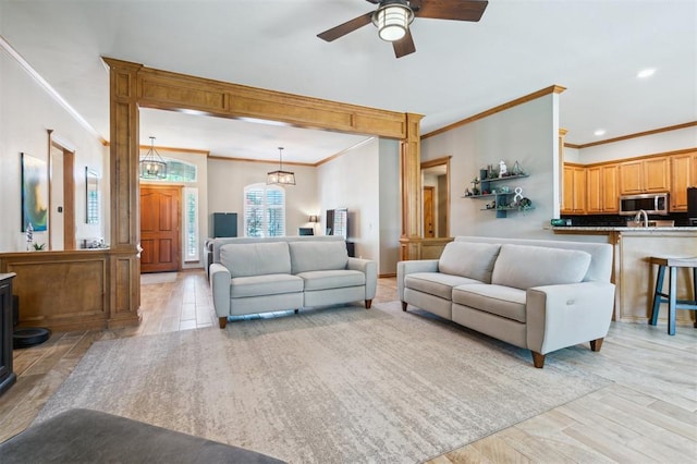 2917 Stafford Rd, Edmond, OK 73012 - living area with ornamental molding, light wood finished floors, ceiling fan, and recessed lighting