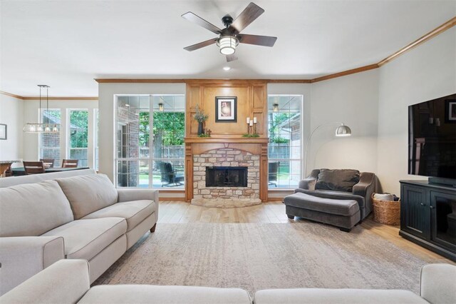 2917 Stafford Rd, Edmond, OK 73012 - living area featuring crown molding, light wood-style flooring, healthy amount of natural light, and a ceiling fan