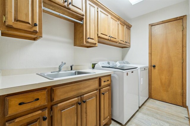 2917 Stafford Rd, Edmond, OK 73012 - laundry room with cabinet space, washing machine and clothes dryer, and light wood-style floors