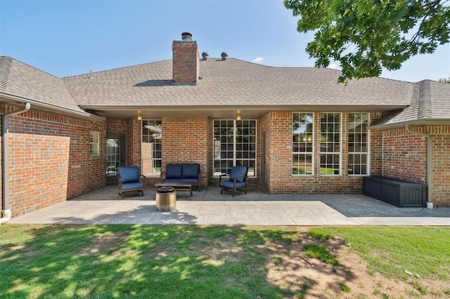 2917 Stafford Rd, Edmond, OK 73012 - back of property featuring a chimney, brick siding, a patio, a shingled roof, and a lawn