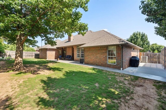 2917 Stafford Rd, Edmond, OK 73012 - back of property with a patio area, brick siding, a fenced backyard, and a chimney