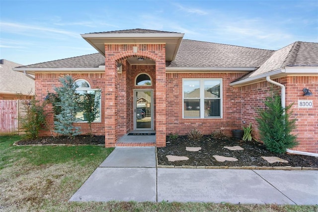 8300 NW 71st St, Oklahoma City, OK 73132 - view of exterior entry with brick siding and roof with shingles