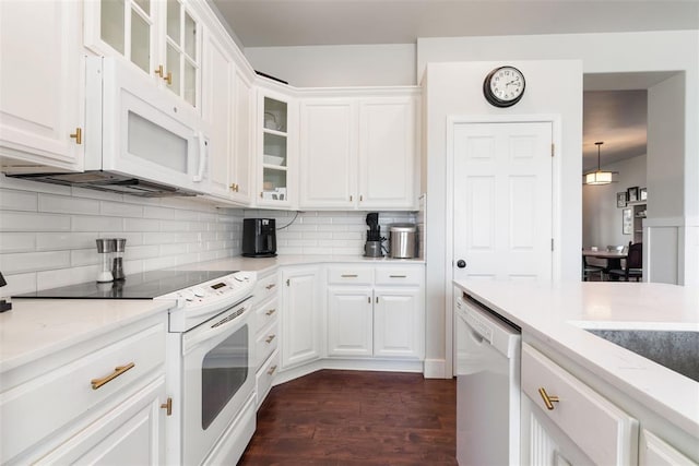 8300 NW 71st St, Oklahoma City, OK 73132 - kitchen with white appliances, dark wood-style floors, white cabinets, backsplash, and light stone countertops