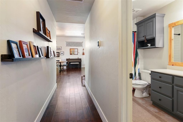8300 NW 71st St, Oklahoma City, OK 73132 - hall with dark wood-style flooring and baseboards