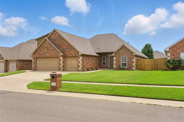 2716 Busheywood Dr, Yukon, OK 73099 - view of front of home featuring brick siding, a garage, concrete driveway, and roof with shingles