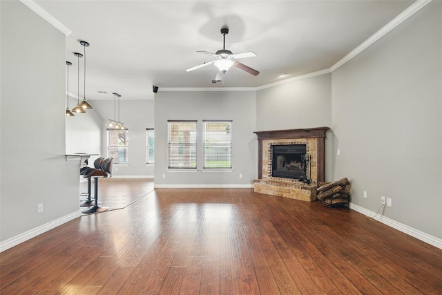 2716 Busheywood Dr, Yukon, OK 73099 - unfurnished living room featuring a brick fireplace, ceiling fan, hardwood / wood-style floors, and crown molding