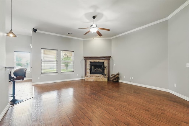 2716 Busheywood Dr, Yukon, OK 73099 - unfurnished living room with a ceiling fan, hardwood / wood-style floors, a fireplace, and crown molding