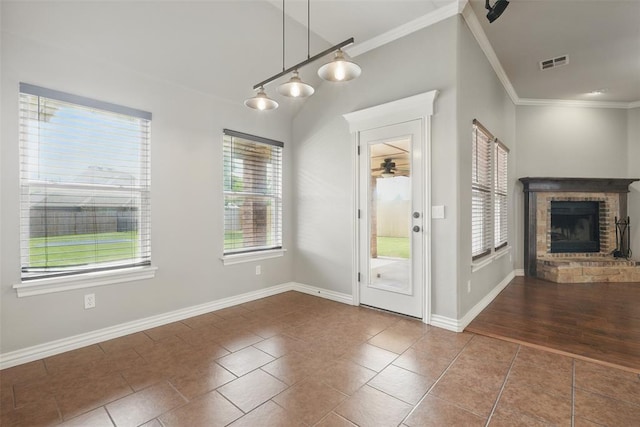 2716 Busheywood Dr, Yukon, OK 73099 - entryway with crown molding, ceiling fan, a fireplace, and tile patterned flooring
