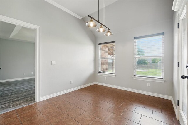 2716 Busheywood Dr, Yukon, OK 73099 - spare room with dark tile patterned floors, lofted ceiling, and crown molding