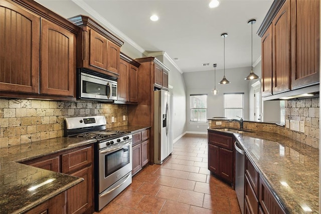 2716 Busheywood Dr, Yukon, OK 73099 - kitchen featuring stainless steel appliances, decorative light fixtures, backsplash, ornamental molding, and dark stone counters