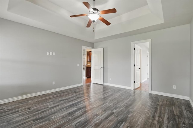 2716 Busheywood Dr, Yukon, OK 73099 - unfurnished bedroom with a raised ceiling, wood finished floors, and a ceiling fan