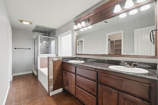 2716 Busheywood Dr, Yukon, OK 73099 - full bath featuring a stall shower, double vanity, a garden tub, and a walk in closet