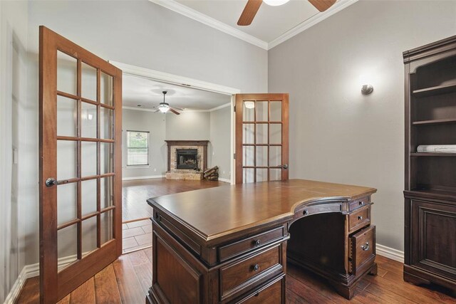 2716 Busheywood Dr, Yukon, OK 73099 - office area featuring ceiling fan, crown molding, dark wood-type flooring, and a stone fireplace