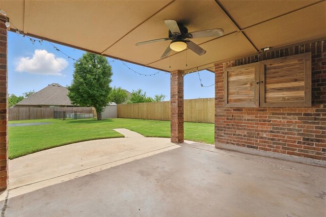 2716 Busheywood Dr, Yukon, OK 73099 - fenced backyard with a ceiling fan, a patio area, and a storage shed