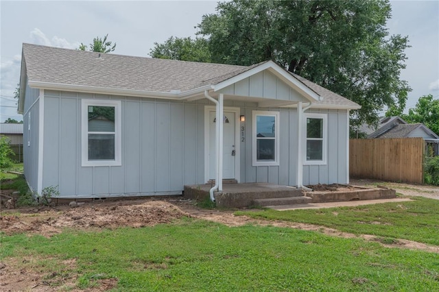 312 SE 45th St, Oklahoma City, OK 73129 - single story home with a shingled roof, board and batten siding, and a porch