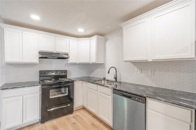 312 SE 45th St, Oklahoma City, OK 73129 - kitchen with dishwasher, black range with electric cooktop, under cabinet range hood, light wood-type flooring, and dark stone counters