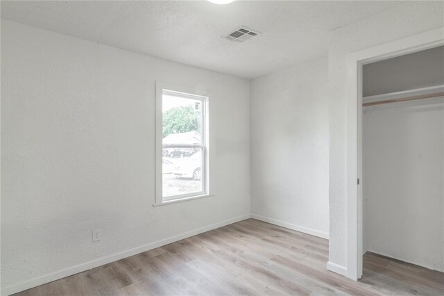 312 SE 45th St, Oklahoma City, OK 73129 - unfurnished bedroom with a closet and wood finished floors