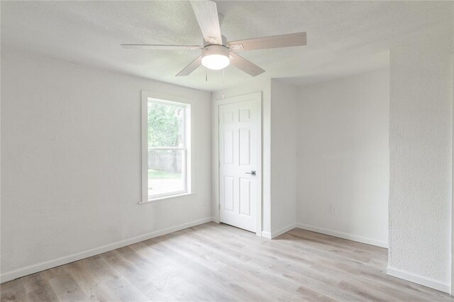312 SE 45th St, Oklahoma City, OK 73129 - spare room featuring wood finished floors, a textured ceiling, and ceiling fan