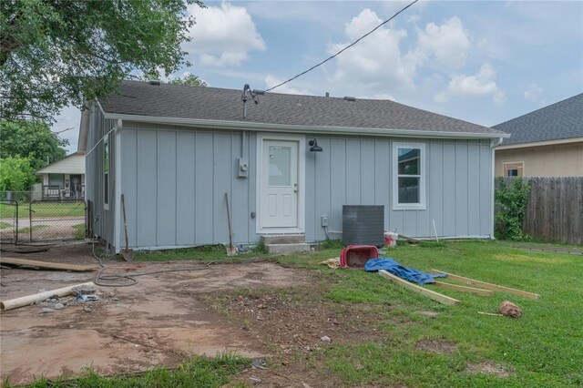 312 SE 45th St, Oklahoma City, OK 73129 - back of property with board and batten siding, entry steps, and roof with shingles