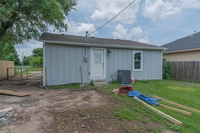 312 SE 45th St, Oklahoma City, OK 73129 - back of property with board and batten siding, a gate, roof with shingles, and entry steps