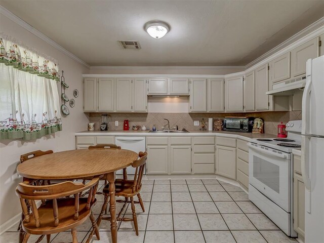 3113 SE 20th St, Oklahoma City, OK 73115 - kitchen with white appliances, under cabinet range hood, crown molding, light countertops, and backsplash