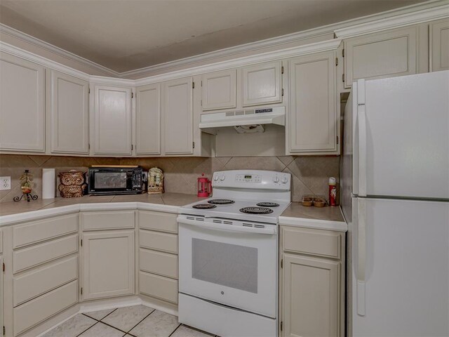 3113 SE 20th St, Oklahoma City, OK 73115 - kitchen featuring white appliances, under cabinet range hood, light countertops, and decorative backsplash